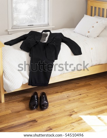 Suit and shoes on bed