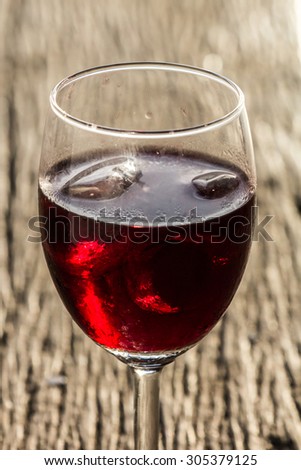 Wine glass on the wooden floor of their home country.