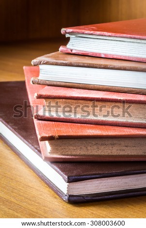 Books hardcover color produced by hand in a medical library, arranged on a wooden table.