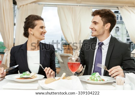 Business comes first. Two colleagues discussing business over meal in a restaurant