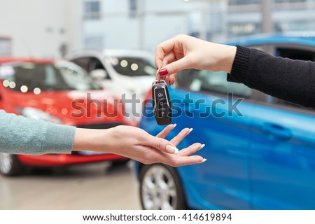 Drive safe. Cropped closeup of a female car owner receiving car keys from the car dealer manager