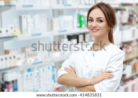 Caring customers with a smile. Horizontal portrait of a beautiful pharmacist smiling to the camera cheerfully posing in the drugstore.