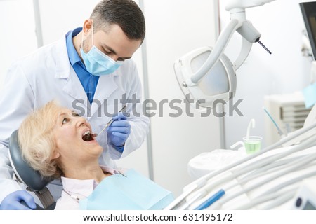 Mature male dentist working with his elderly patient senior woman visiting dentist having dental checkup at the clinic dentistry occupation treatment medical industry healthcare people insurance