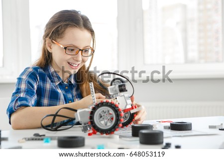 Shot of a cute young girl smiling joyfully building a robot copyspace constructor engineering playing childhood kids hobby leisure lifestyle people toys robotics technology intelligence learning