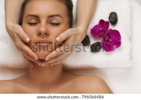 Top view shot of a young beautiful woman receiving face massage by a professional spa therapist at the luxurious resort copyspace hotel treatment anti-aging soothing recreation pampering skincare