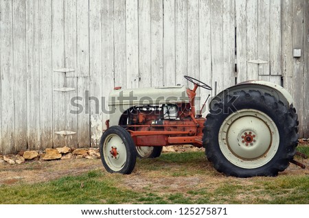 Vintage tractor by barn