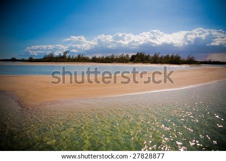 Sand bar divides blue and green sea water of the Caribbean Sea