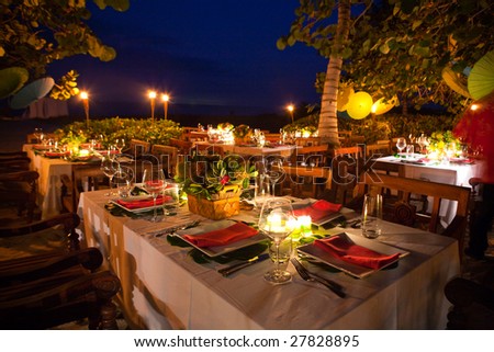 Place Settings On A Dinner Table Await Their Guests. Stock Photo