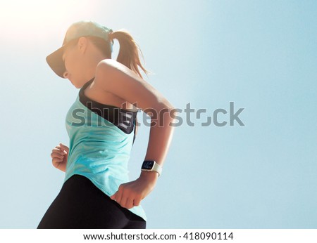 Smart watch on a sporting girl wrist. Smart watch health, heart rate and fat burn monitoring. Jogging goals preparation. Bright everyday sport concept mock up. Lifestyle concept.