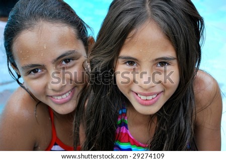 Beautiful Hispanic Sisters by the pool