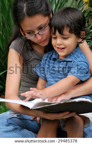 Young Hispanic mother reads a story with her son