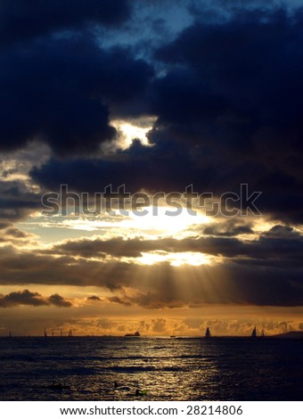 Sunset over Boats and Ships travelling to/from Honolulu Harbour, Hawaii.  Photograph taken from Waikiki Beach.