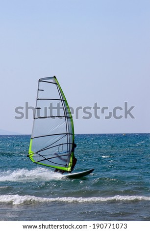 A windsurfer passing by