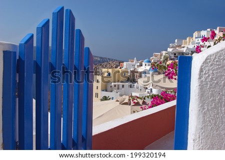 View through an opened gate to a village in Santorini island, Greece