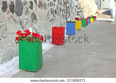 Row of flower pots in an alley in Santorini, Greece