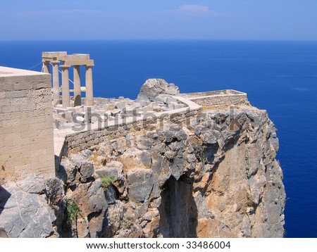 Ruins of ancient Greek temple with columns on the cliff above the sea. Lindos, Rhodes