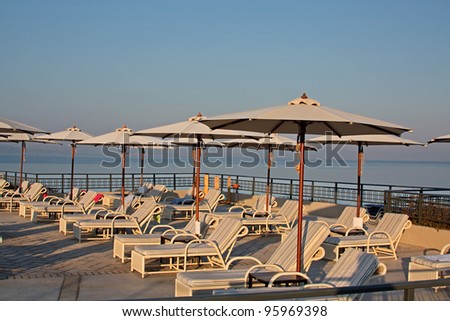 Pool chairs and umbrellas. Luxury Mediterranean hotel