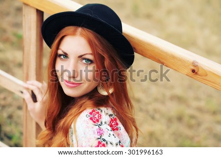 Closeup of the face with clean skin and freckles belong to beautiful young sexy red-haired girl with curly hair. Trendy, lifestyle