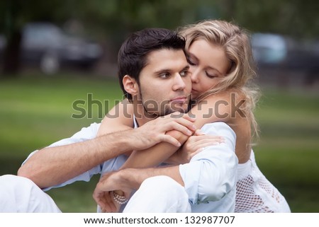 portrait of a young couple in the park on the lawn in the park