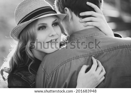 cute young girl hugging a loved looking over her shoulder at the camera