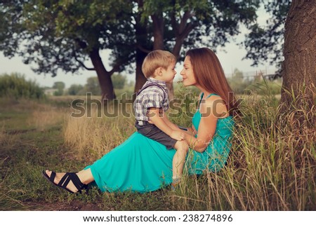 mother and son sitting face to face outdoors