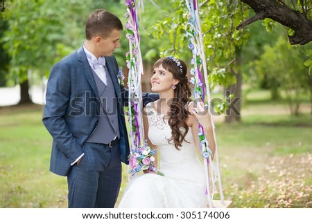 portrait of the bride and groom on a swing