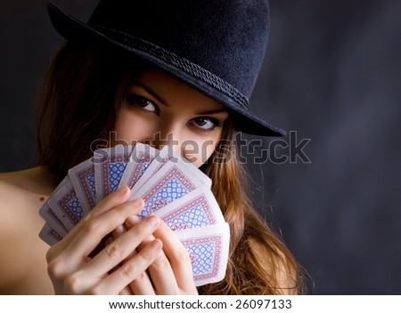 Girl with cards and in a black hat.