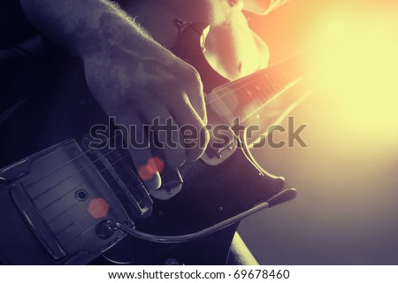 man playing electrical guitar in black and yellow