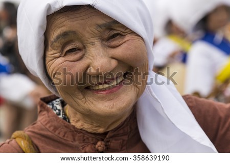Jeju Island, South Korea. October 2015 - An Old lady dances and smile during a Fall festival in Seogwipo.