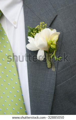 stock photo Boutonniere on Grey Suit w green tie
