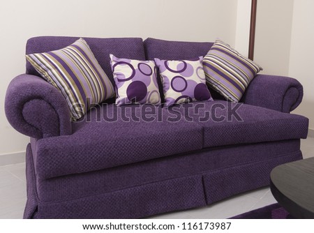 Living room lounge in a luxury apartment showing purple interior design