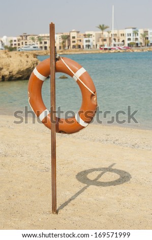 Life ring buoy safety equipment hanging on a tropical beach