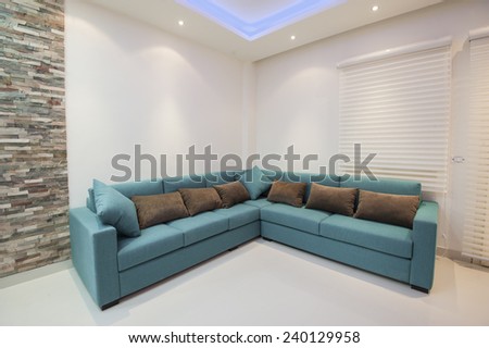 Corner sofa with cushions in luxury apartment living room