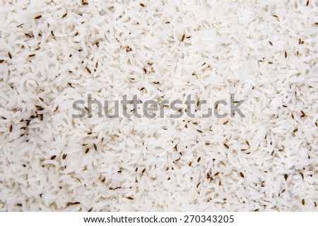 Closeup detail of jeera pilau rice on display at an indian restaurant buffet creating background wallpaper