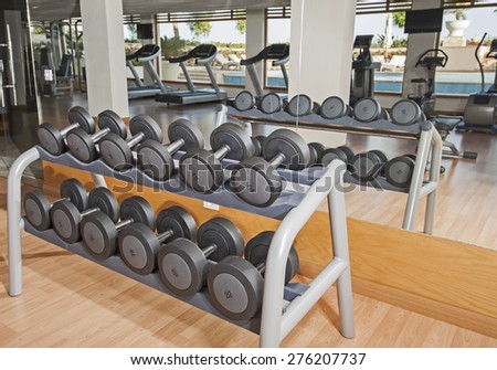 Row of dumbell weights on a rack in luxury health center gym