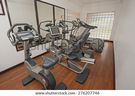 Exercise machines in luxury private health center gym room