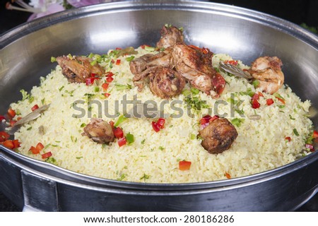 Oriental kabsa rice dish with chicken on display at a hotel restaurant buffet