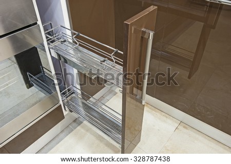 Small sliding cupboard shelf unit in a luxury kitchen interior