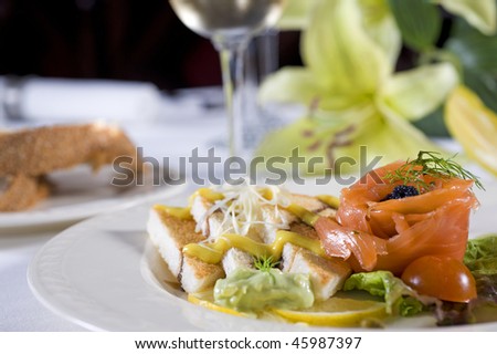 Smoked salmon with toast appetizer on white plate