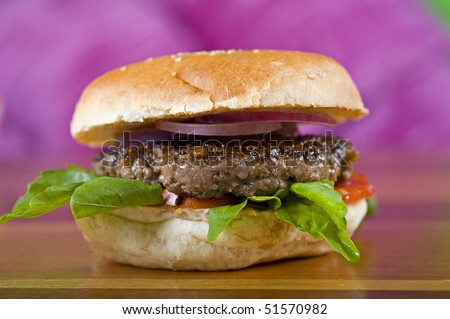 Beef burger with salad in a white bread bun