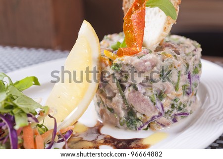 A la carte tuna tartare appetizer dish in a restaurant