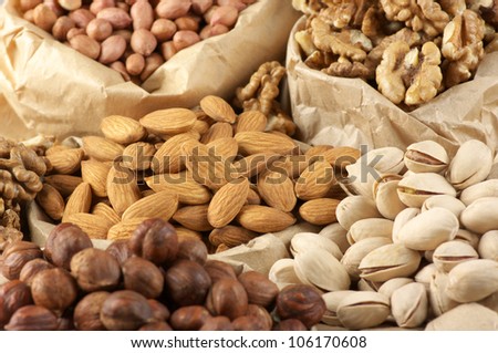 Close-up of assorted nuts in paper bags.