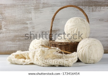 Natural Woolen Yarn And Knitting On Vintage Wooden Background.