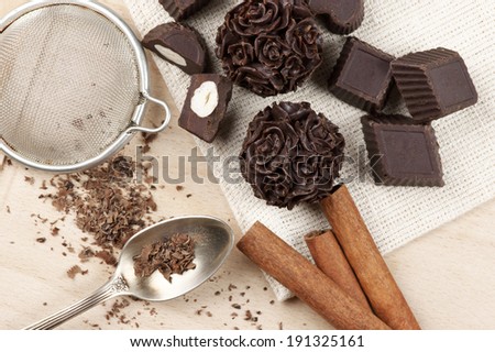 Homemade natural chocolate candies with ingredients on wood.