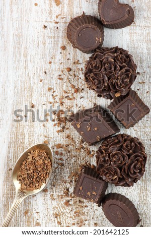 Homemade natural chocolate candies on rustic wooden background.