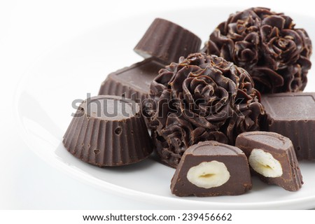 Homemade natural chocolate candies on white background.