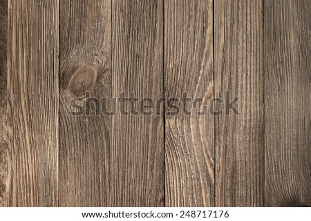 Natural knotted brown weathered wood plank texture background.