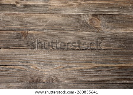 Natural knotted brown weathered wood plank texture background.