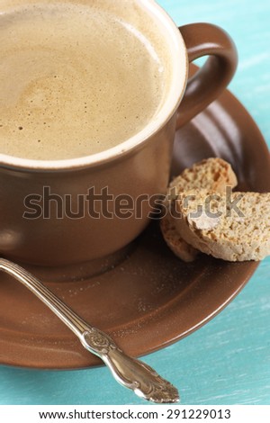 Cup of coffee latte and almond cookies close-up.