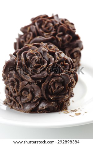 Homemade natural chocolate candies on white background.